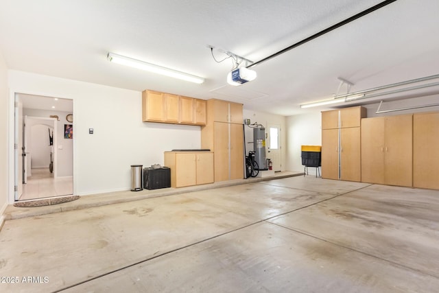 garage featuring a garage door opener and water heater