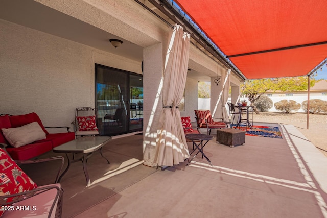 view of patio / terrace featuring fence