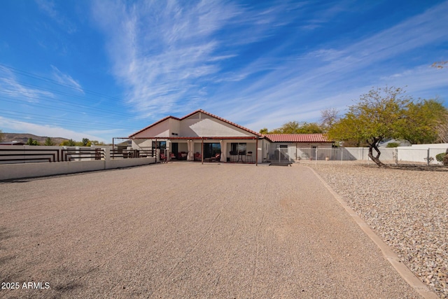 view of front of home featuring a tile roof and fence