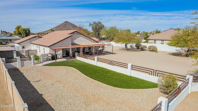 view of front of home featuring a patio and a fenced backyard