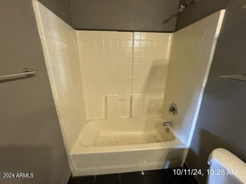 bathroom featuring bathtub / shower combination, tile patterned flooring, and toilet