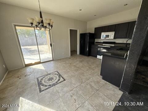 kitchen with sink, hanging light fixtures, white appliances, and an inviting chandelier