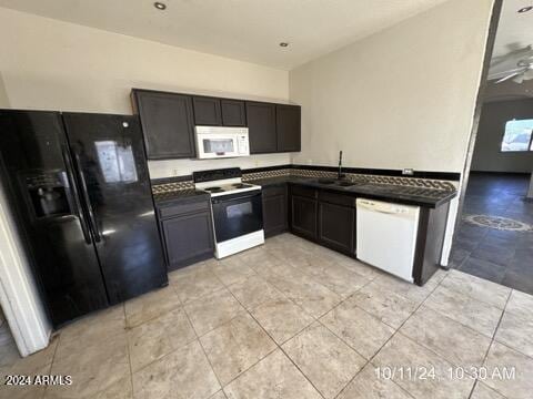 kitchen featuring ceiling fan, dark brown cabinets, white appliances, and sink