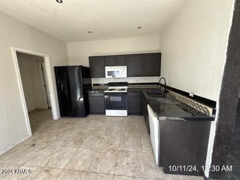 kitchen featuring sink and white appliances