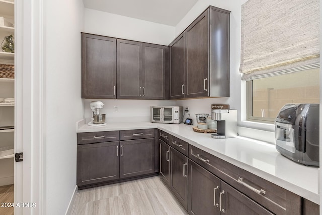 kitchen featuring dark brown cabinets