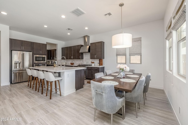 dining area featuring light tile floors