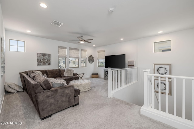 carpeted living room with ceiling fan