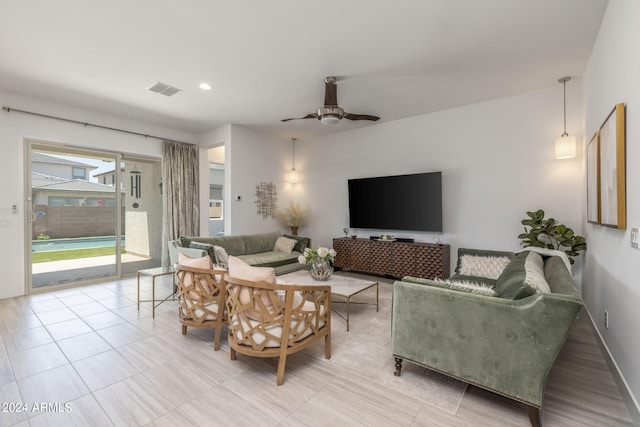 living room with ceiling fan and light tile floors