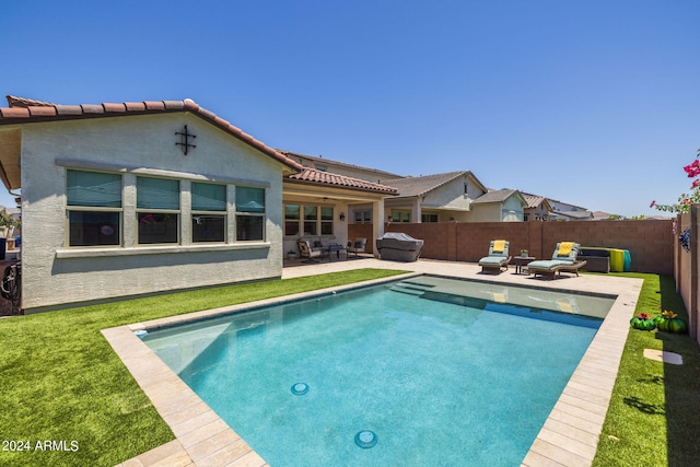 view of swimming pool featuring outdoor lounge area, a yard, and a patio area