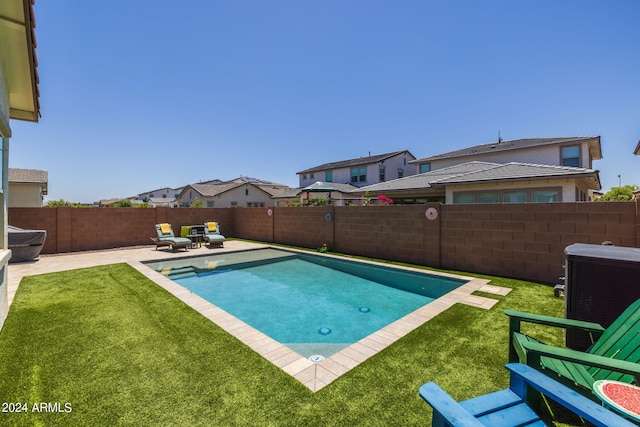 view of swimming pool featuring a yard and a patio area