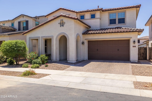 mediterranean / spanish-style home featuring a garage