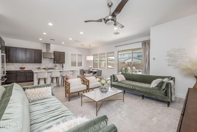 living room featuring light wood-type flooring and ceiling fan