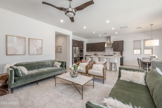 tiled living room featuring ceiling fan