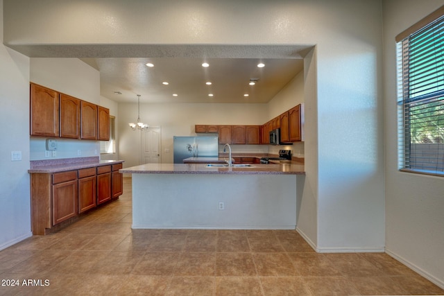 kitchen featuring sink, stainless steel appliances, decorative light fixtures, light tile patterned floors, and a chandelier