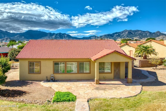 rear view of house featuring a mountain view and a patio