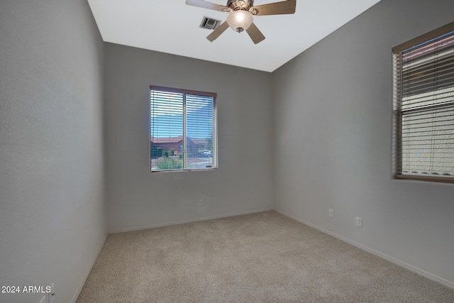 unfurnished room with light carpet, lofted ceiling, and ceiling fan