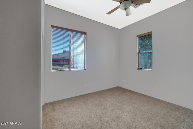 spare room featuring carpet floors and ceiling fan