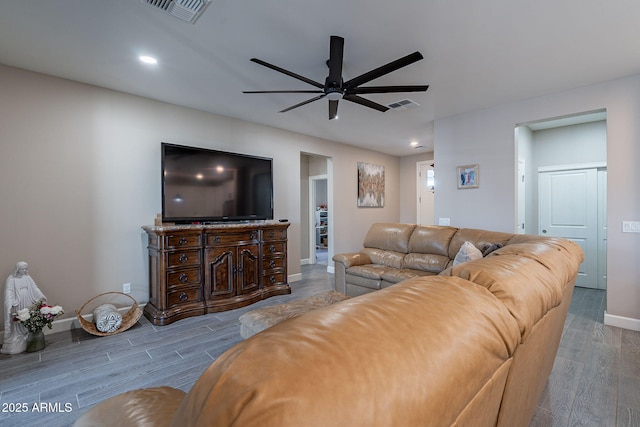 living room featuring ceiling fan and light hardwood / wood-style flooring