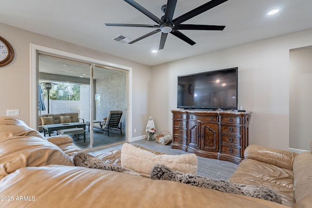 living room featuring ceiling fan and light hardwood / wood-style floors