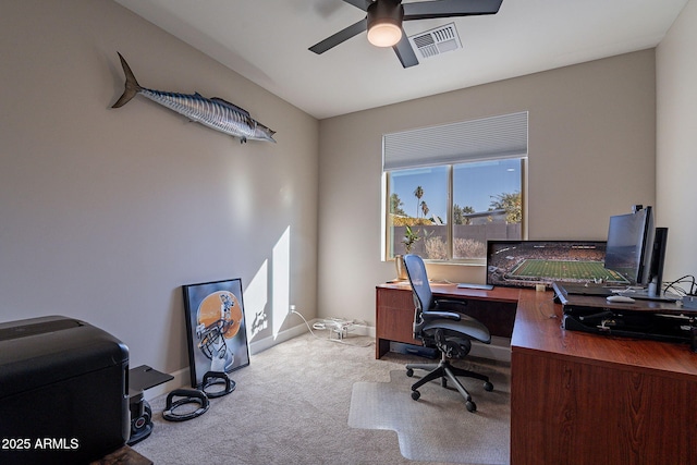 carpeted office space with ceiling fan