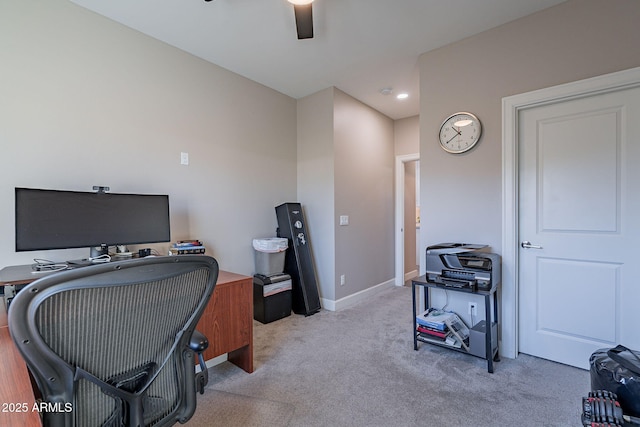 carpeted office space featuring ceiling fan