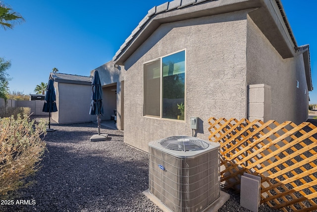 view of side of home featuring central AC