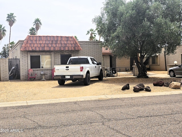 18227 N 40th Pl, Phoenix, AZ 85032 - view of front of property with mansard roof, fence, brick siding, and a tiled roof