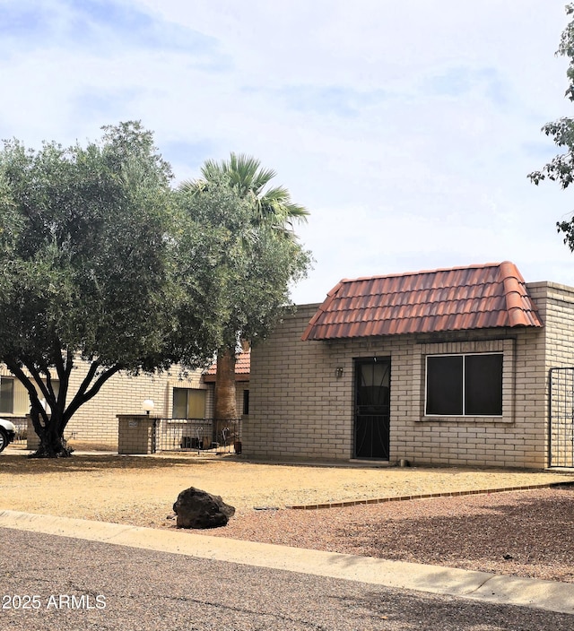 18227 N 40th Pl, Phoenix, AZ 85032 - front facade featuring brick siding, mansard roof, and fence