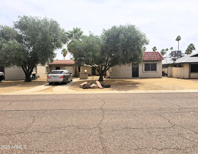 18227 N 40th Pl, Phoenix, AZ 85032 - view of front of house featuring driveway, brick siding, central AC unit, and an attached garage