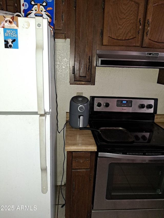 18227 N 40th Pl, Phoenix, AZ 85032 - kitchen featuring freestanding refrigerator, electric stove, extractor fan, and dark brown cabinetry