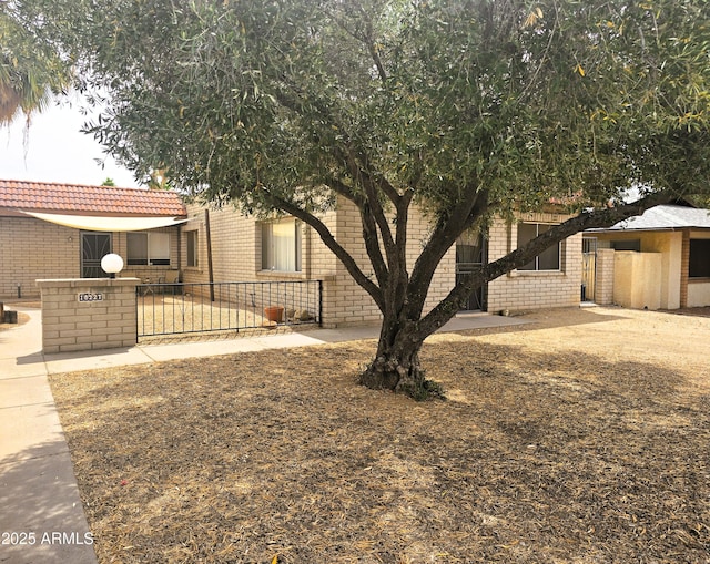 18227 N 40th Pl, Phoenix, AZ 85032 - view of front of home with fence, a tile roof, and brick siding