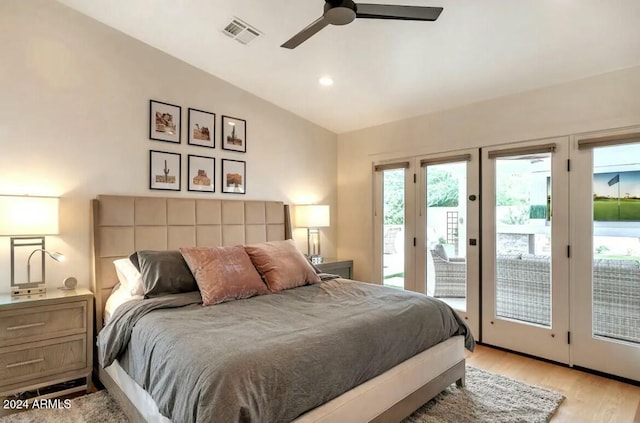 bedroom featuring access to outside, vaulted ceiling, and multiple windows