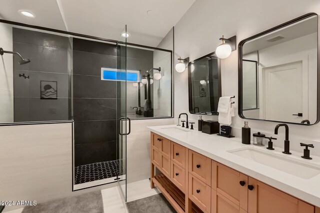 bathroom with tile patterned flooring, vanity, and walk in shower