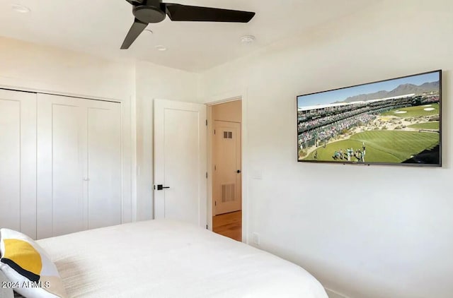 bedroom with ceiling fan and a closet