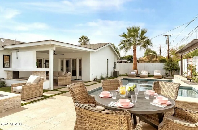 view of patio / terrace featuring french doors, a fenced in pool, and ceiling fan