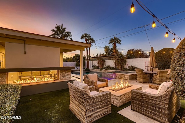 patio terrace at dusk featuring an outdoor fire pit