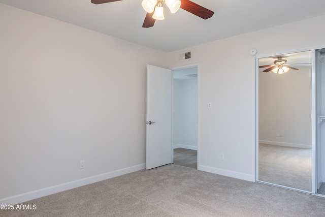 unfurnished bedroom featuring baseboards, carpet flooring, a closet, and visible vents