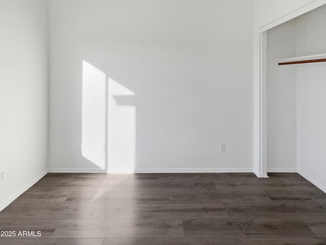 unfurnished bedroom featuring dark hardwood / wood-style flooring and a closet