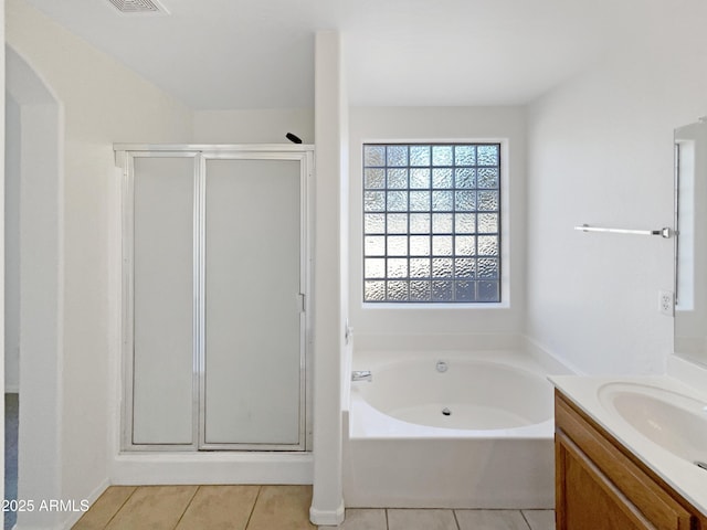 bathroom featuring tile patterned flooring, vanity, and independent shower and bath