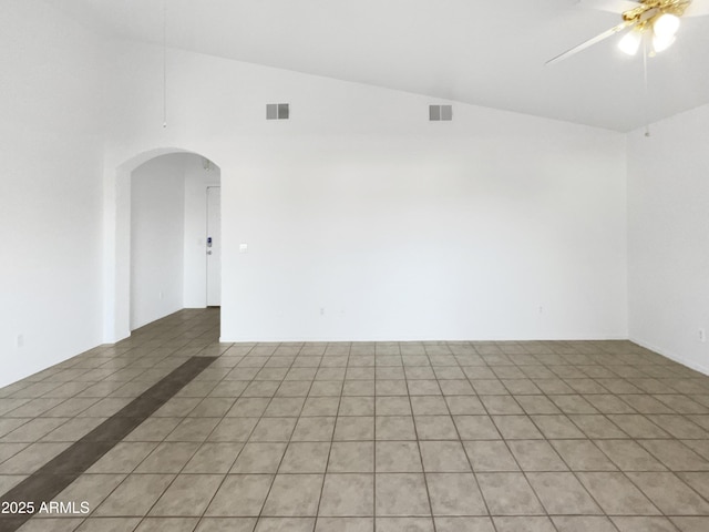 empty room with light tile patterned flooring, ceiling fan, and lofted ceiling