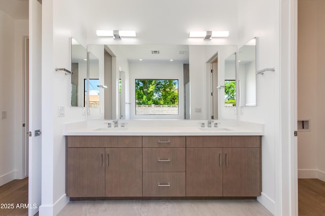100 W Northern Ave Unit 12, Phoenix, AZ 85021 - bathroom with a sink, double vanity, baseboards, wood finished floors, and visible vents