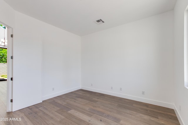 100 W Northern Ave Unit 12, Phoenix, AZ 85021 - empty room with baseboards, visible vents, and wood finished floors