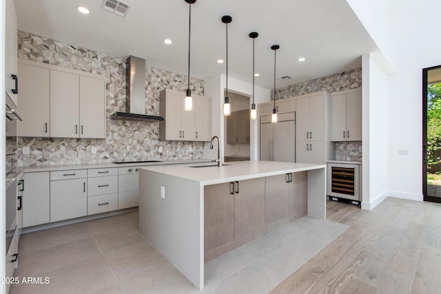 100 W Northern Ave Unit 12, Phoenix, AZ 85021 - kitchen featuring wall chimney range hood, a sink, wine cooler, backsplash, and built in refrigerator