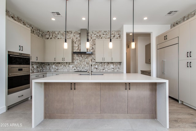 100 W Northern Ave Unit 12, Phoenix, AZ 85021 - kitchen featuring visible vents, a spacious island, a sink, built in refrigerator, and wall chimney exhaust hood