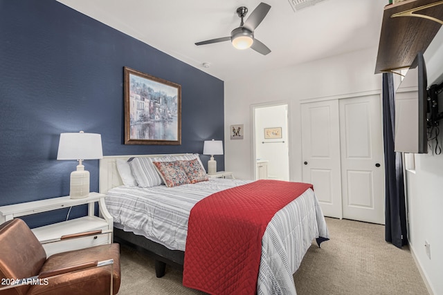 carpeted bedroom with a closet and ceiling fan