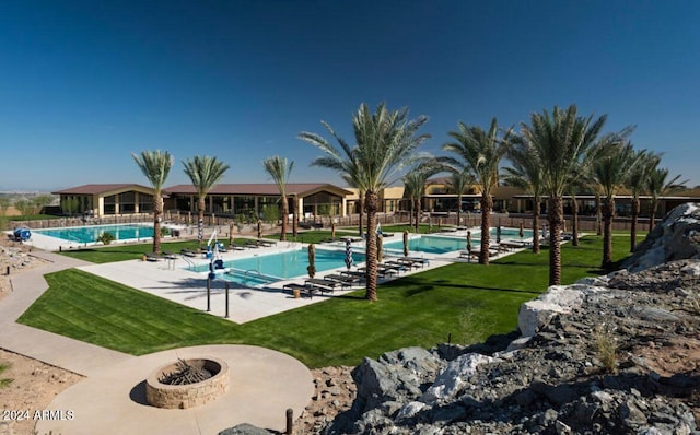 view of pool with a patio area and a lawn