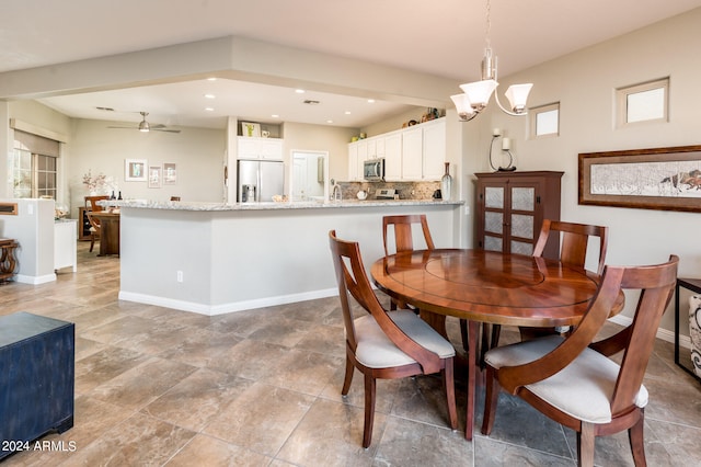 dining space featuring ceiling fan with notable chandelier and a wealth of natural light