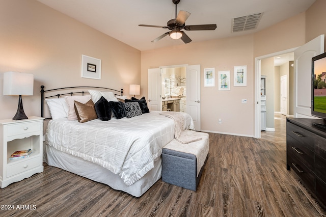 bedroom with ensuite bath, ceiling fan, and dark hardwood / wood-style flooring