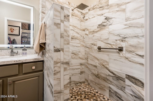 bathroom featuring vanity and tiled shower