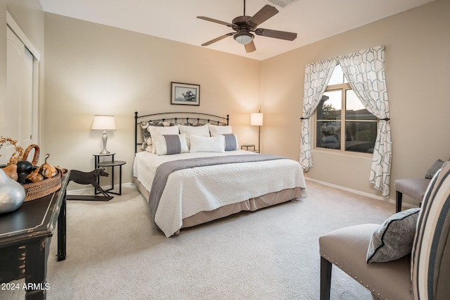 bedroom with light colored carpet, a closet, and ceiling fan